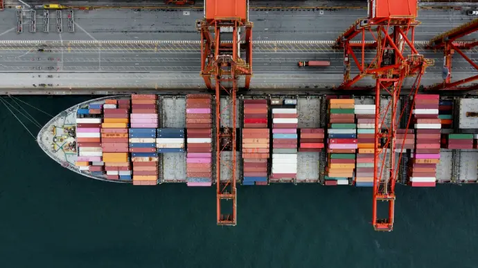 Cargo ship loaded with colorful containers at a port